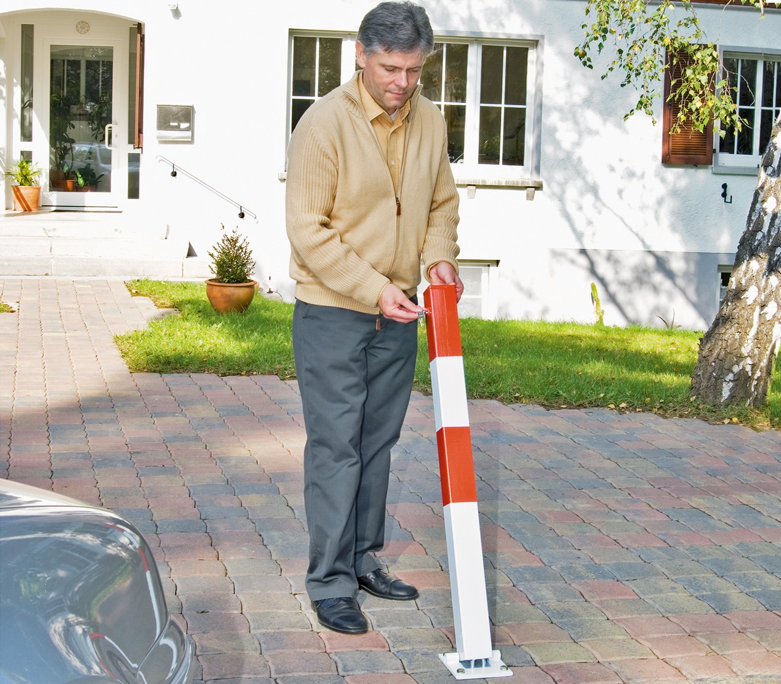 Poteau de délimitation amovible avec clé triangulaire ou cylindre à clé sur parking avec pavé autobloquant